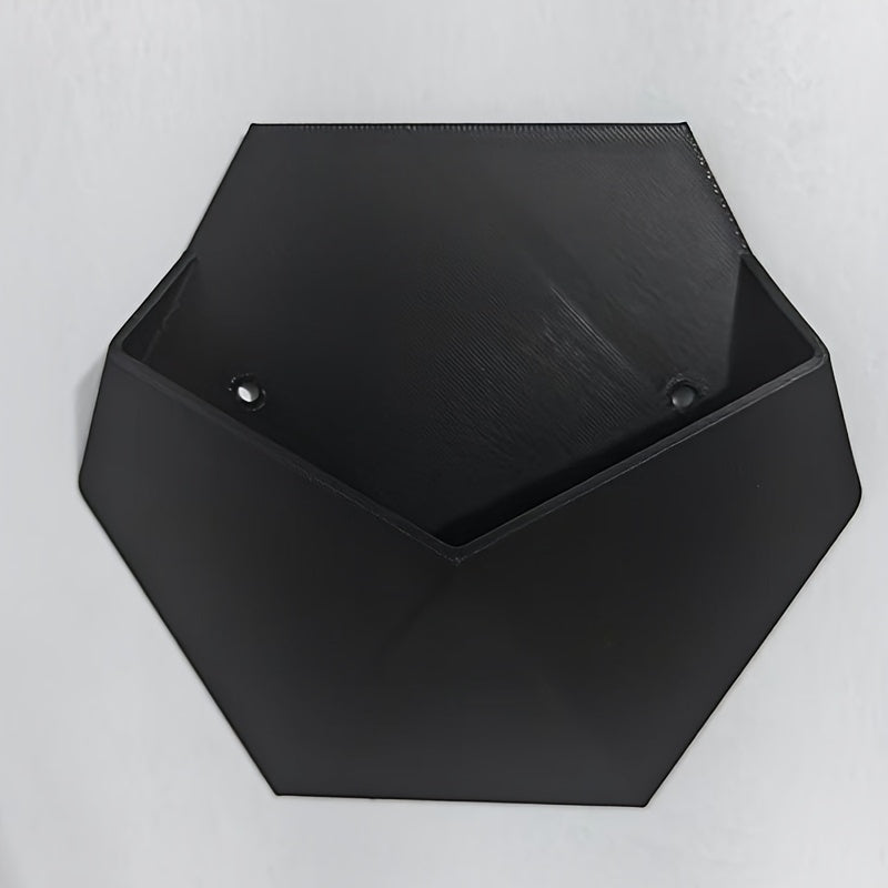 Black hexagonal wall planter with two mounting holes, open top and angled front.
