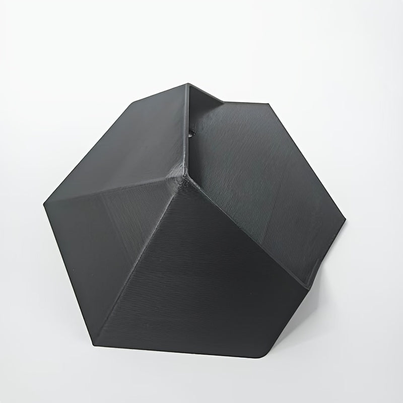 Black hexagonal wall planter with open cavity and inner seam detail, angled view.