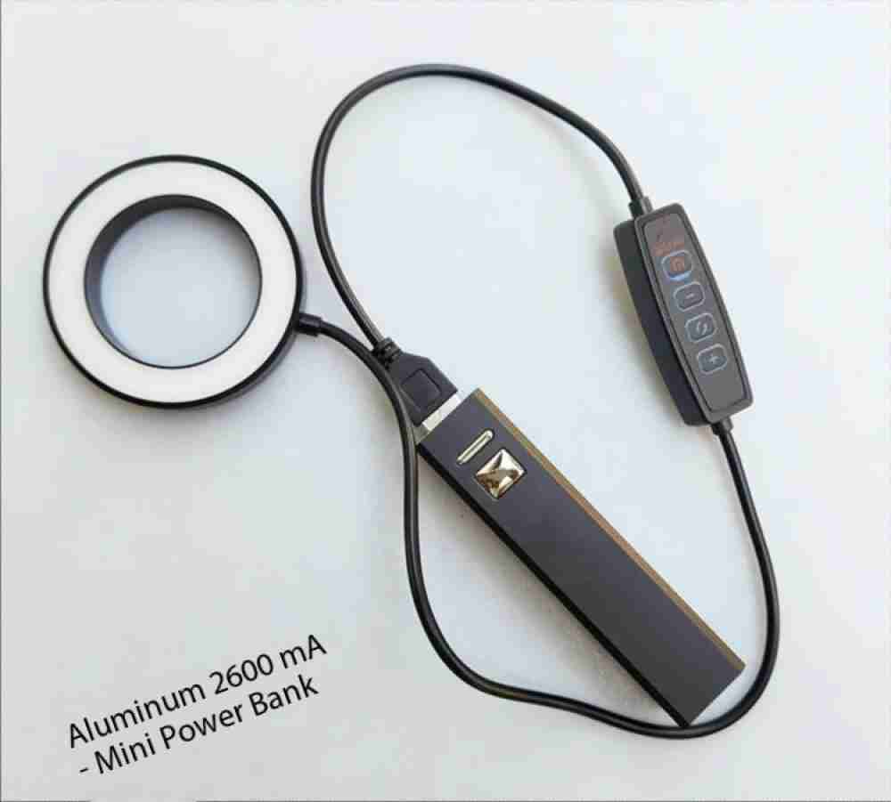 Black 2600mAh aluminum mini power bank connected to a small circular LED ring light with a remote control.