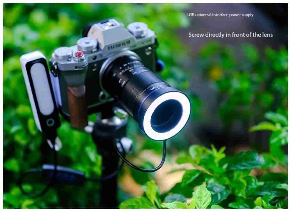Circular USB-powered LED macro ring light attached to a camera lens for close-up lighting.