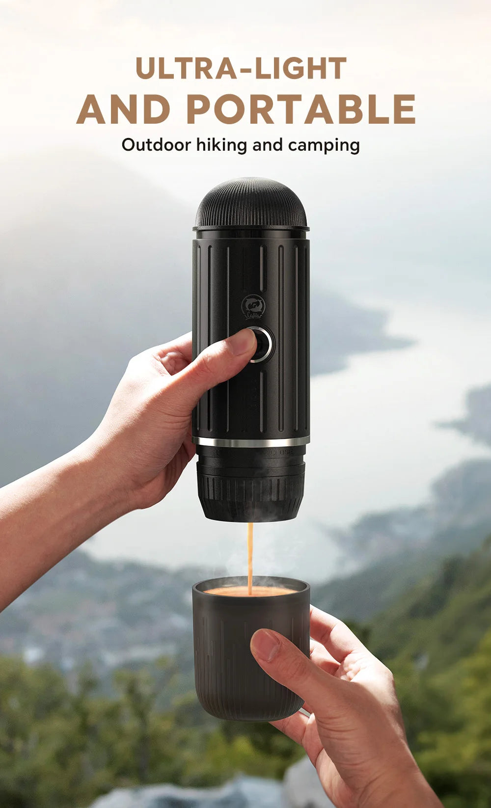 Black portable coffee maker for camping, handheld espresso press with matching cup, outdoors mountain background.