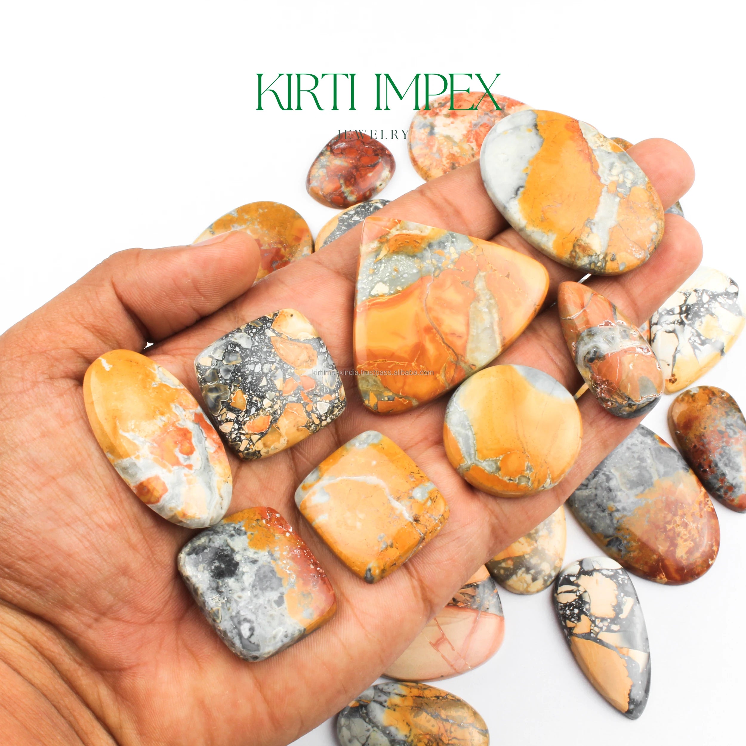 Jasper cabochons with orange patches in hand, natural flat-back loose gemstones