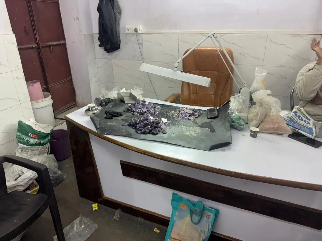 Workbench display with scattered small purple and dark stones