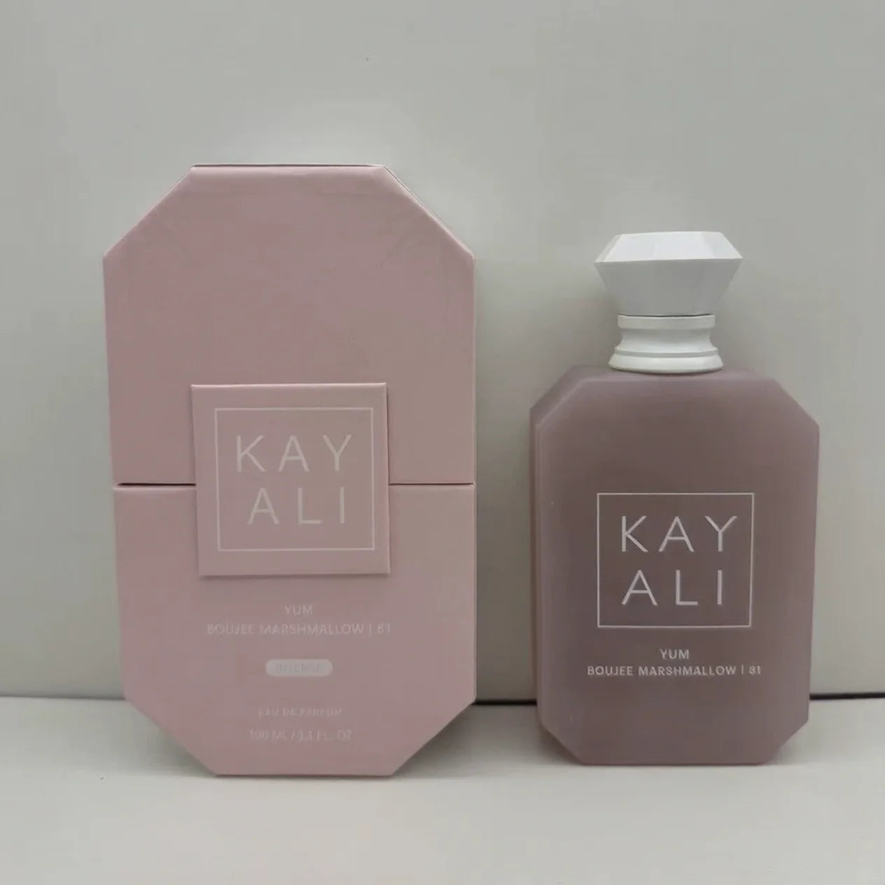 Kayali Yum Boujee Marshmallow 31 perfume in a matte mauve 100ml octagonal bottle with white cap and matching box.