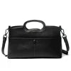 Black luxury PU leather designer handbag with top handle, crossbody strap, and minimalist rectangular frame.