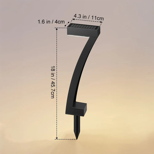 Black number-seven-shaped solar LED pathway light with dimensions 18x4.3x1.6 inches on a ground stake.