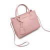 Luxury dusty pink PU leather designer handbag with top handles, crossbody strap, and chic dangling luggage tag charm.