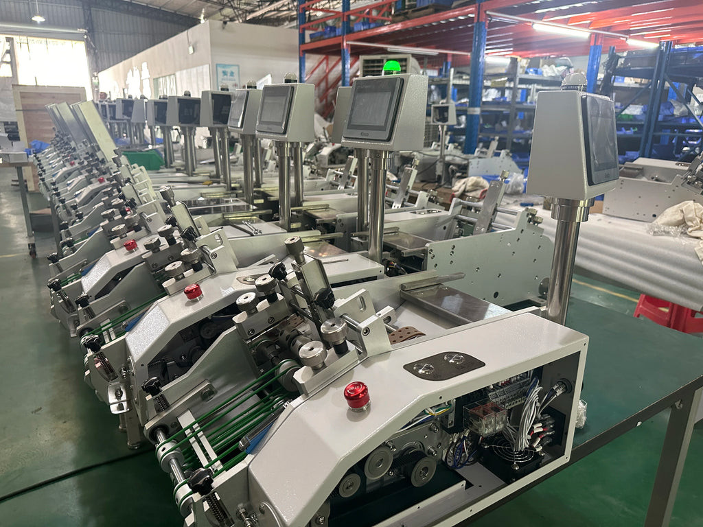 Industrial label feeder machine line with multiple stations and control panels in workshop
