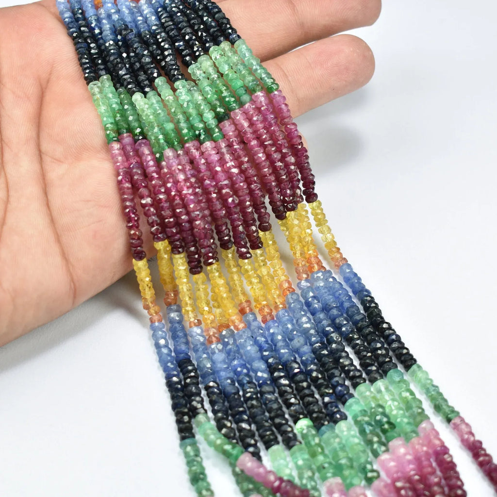 Faceted rondelle bead strand close-up with maroon, green, blue, and yellow bead rows