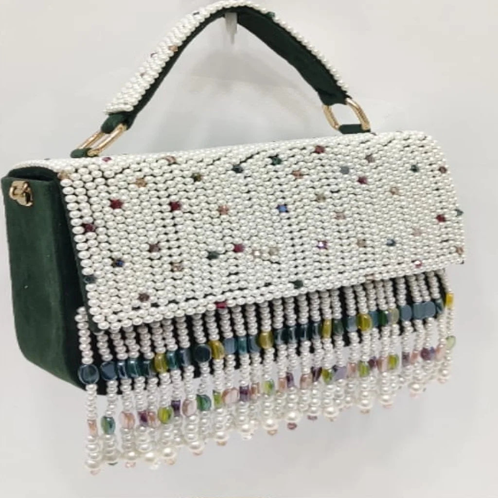 Dark green velvet luxury handbag with pearl beading, multicolor crystal accents, and hanging beaded tassel fringe.