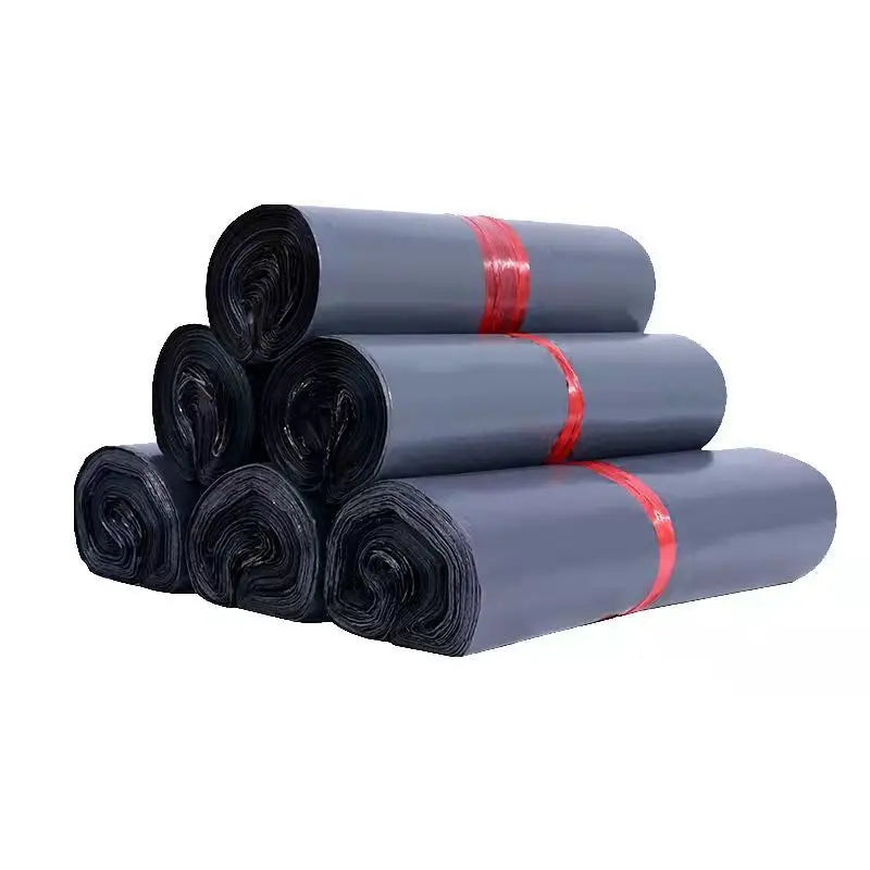 Dark gray waterproof poly mailer bag rolls with red tie bands