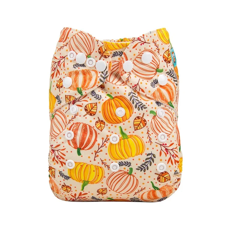 Reusable cloth diaper for babies with an orange and yellow pumpkin and fall leaf print.