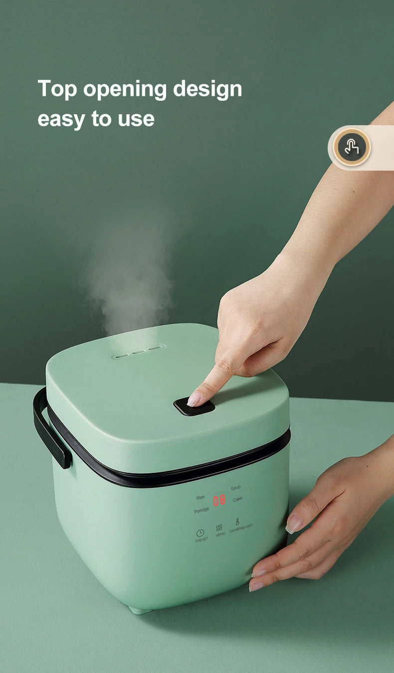Mint-green rice cooker with top-opening lid and side handles, ready to lift