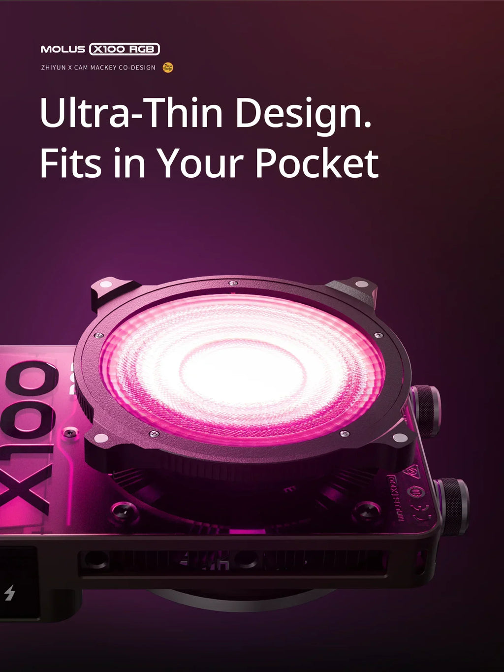 MOLUS X100 RGB compact rectangular LED light with a circular black head emitting vibrant pink light for photography.