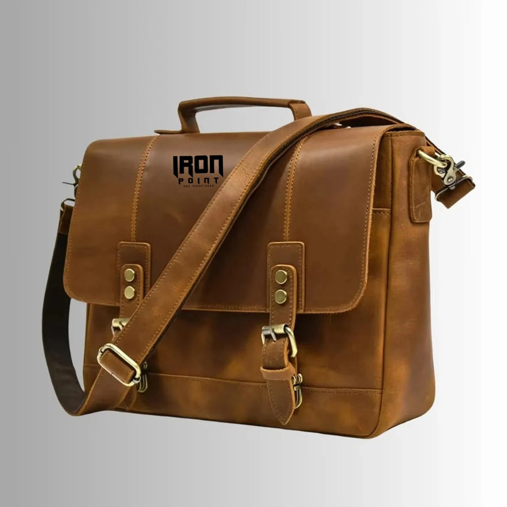 Brown leather business briefcase with buckle straps, top handle, adjustable shoulder strap, and IRON POINT branding.