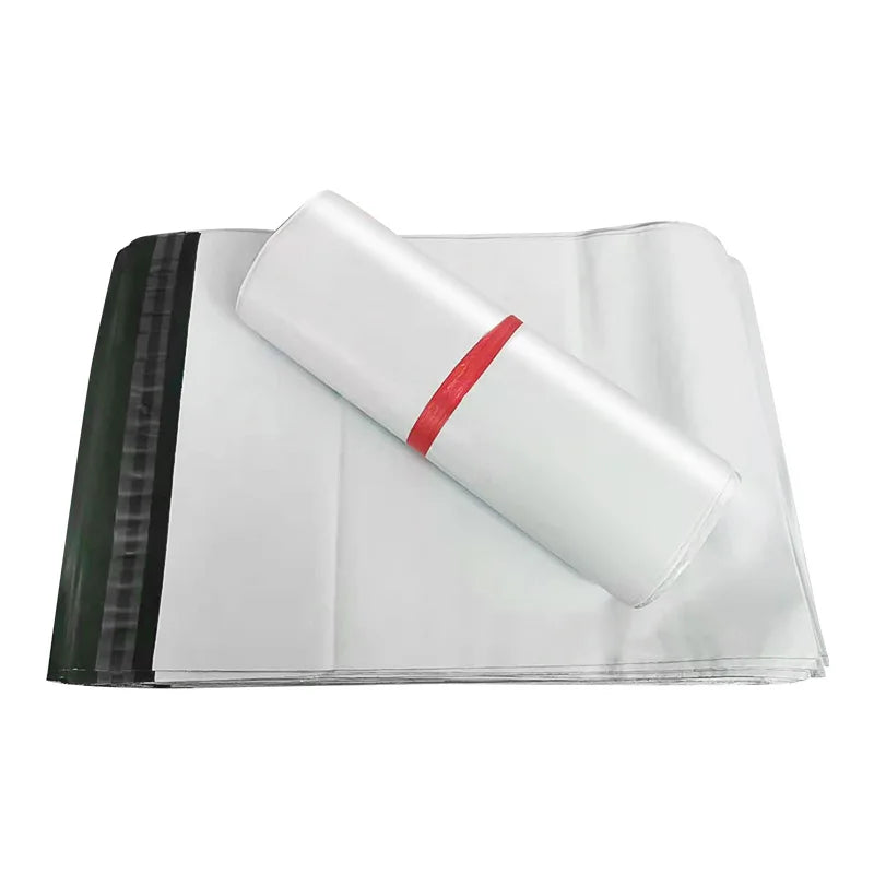 White plastic mailer bag sheets with red sealing strip, folded for packaging