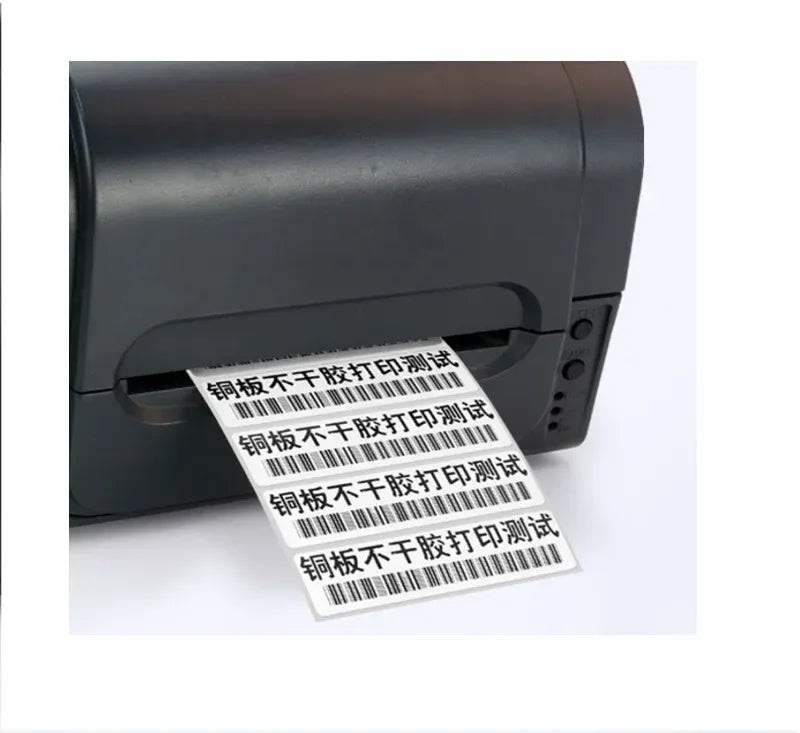 White barcode label sticker being printed from a black label printer