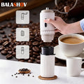 Balashov portable white manual coffee grinder with hand crank, steel body, and coffee bean background.