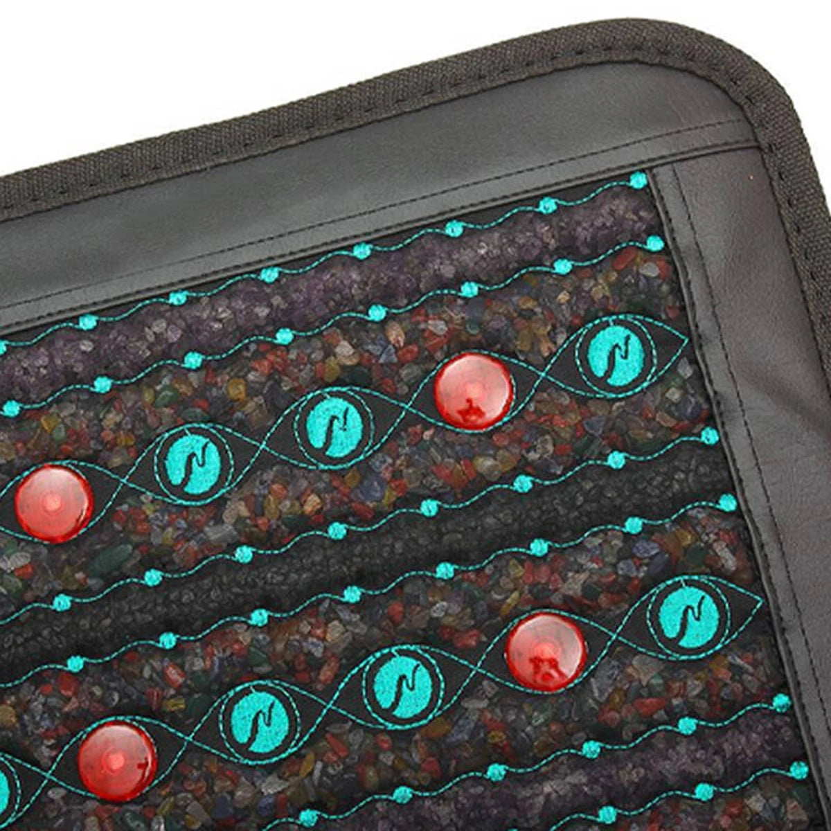Infrared therapy mat with embedded crushed semi-precious stones, red circular discs, and teal decorative stitching.