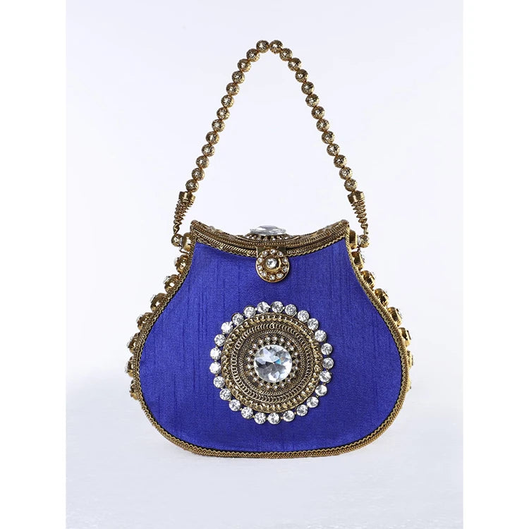 Blue silk designer clutch with gold metal beading, kiss lock closure, and a central crystal rhinestone medallion.