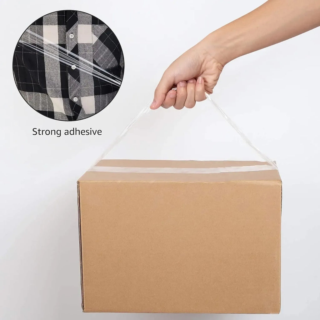 Clear adhesive packing tape sealing a cardboard box top; roll held in hand