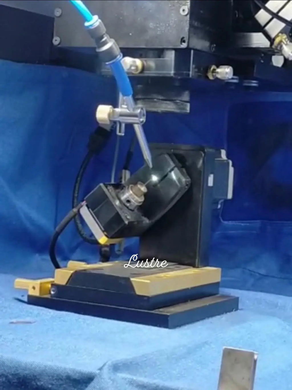 Bead strand production machine on a workbench, with tools and clamp