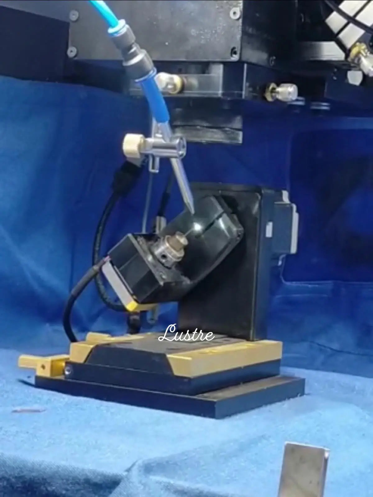 Bead strand production machine on a workbench, with tools and clamp