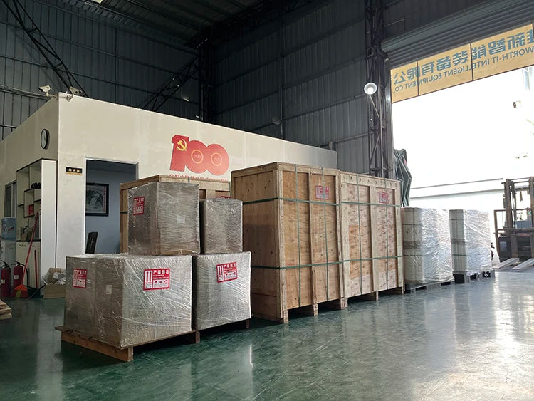 Warehouse floor with palletized cardboard boxes for shipping next to equipment