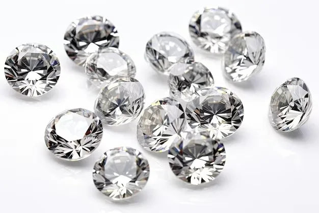 Loose round brilliant diamonds, multiple white stones spread out for viewing