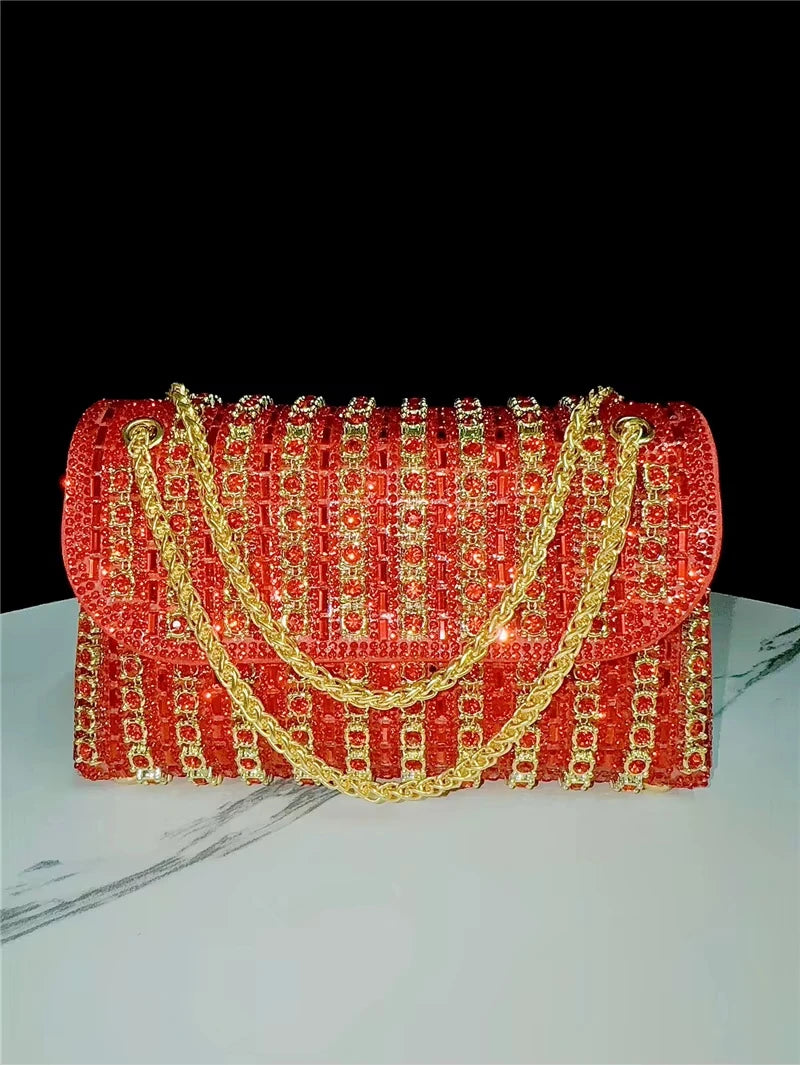 Red crystal-embellished trunk crossbody handbag with gold chain strap, evening designer shoulder purse.