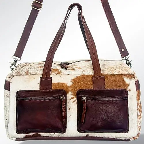 Handmade vintage Western duffel bag in white and brown cowhide leather with two dark brown front zip pockets. Trunk.