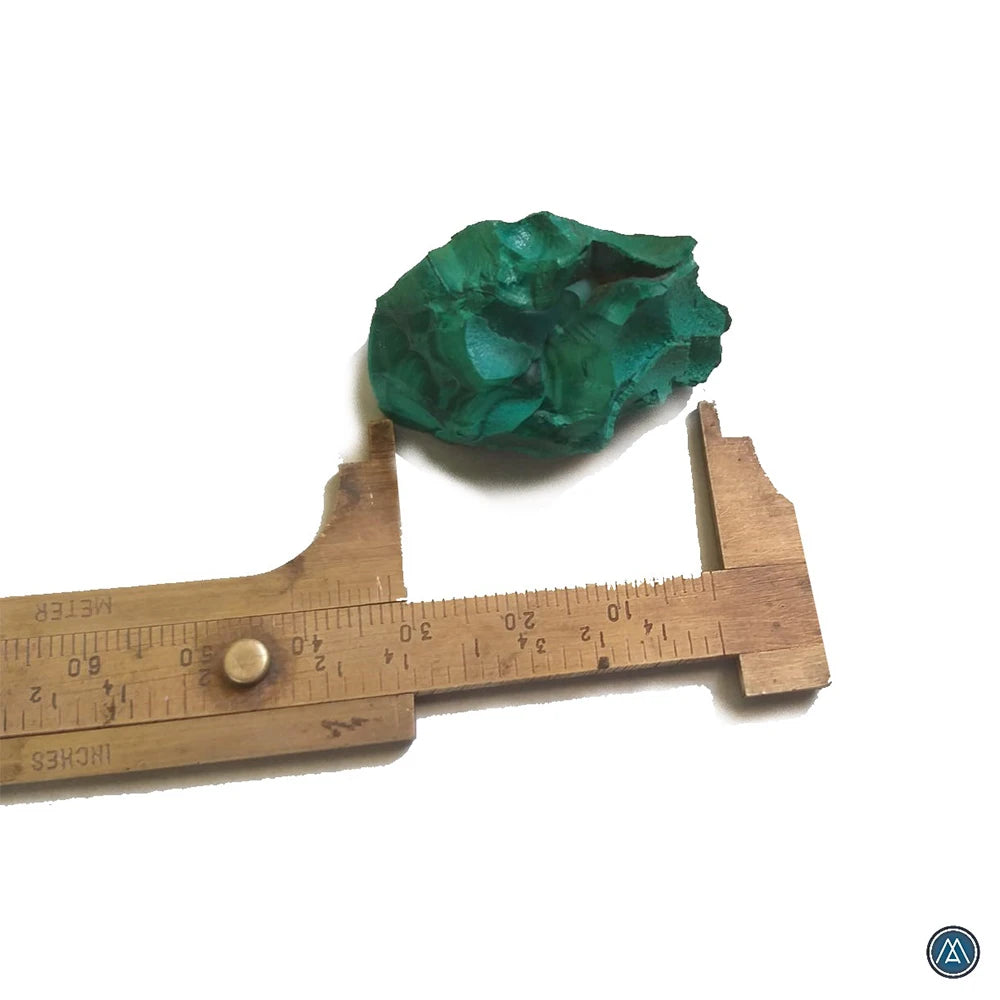 Raw green malachite crystal with wooden measuring ruler for size reference