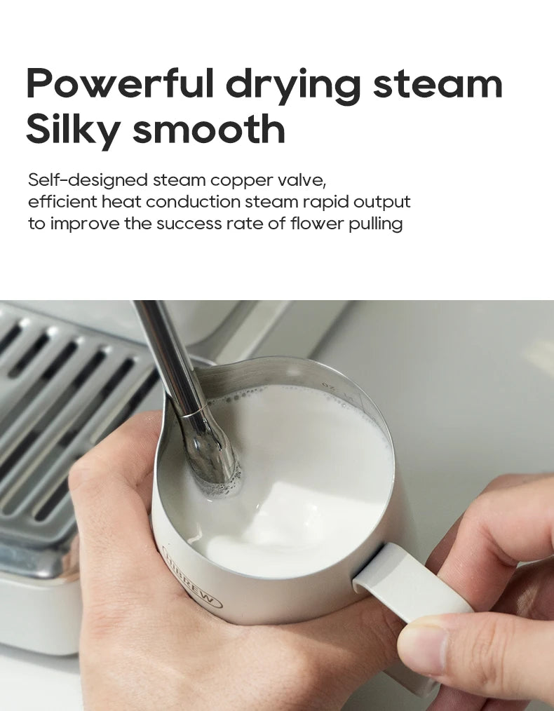 HiBREW espresso machine steam wand frothing milk in a white stainless steel pitcher for latte art.