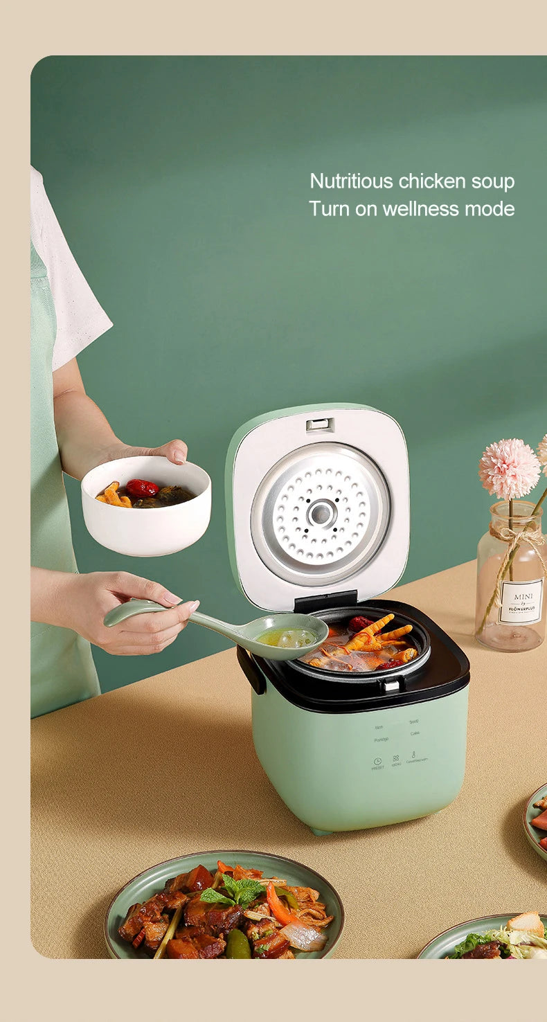 Mini electric rice cooker with open lid showing cooking interior, mint green body on kitchen counter