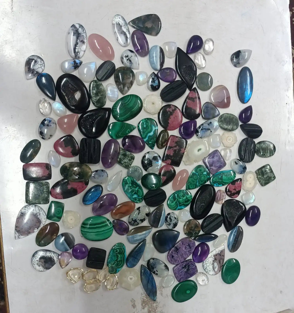 Mixed cabochon gemstone assortment with oval and teardrop stones in multicolor tones