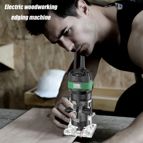 Compact electric wood engraving trimmer held by hand over a workpiece with bit inserted
