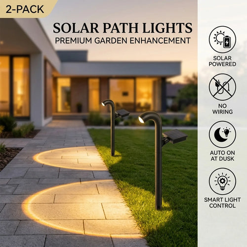 2-pack black solar pathway lights, two stake lamps casting warm light along a garden walkway