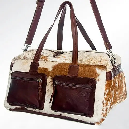 Vintage-style cowhide leather duffel travel bag with brown leather pockets, dual straps, and adjustable shoulder strap.