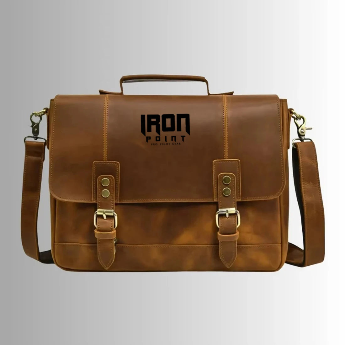 Brown leather business laptop messenger bag with dual buckle straps, top handle, and detachable shoulder strap. Trunks.