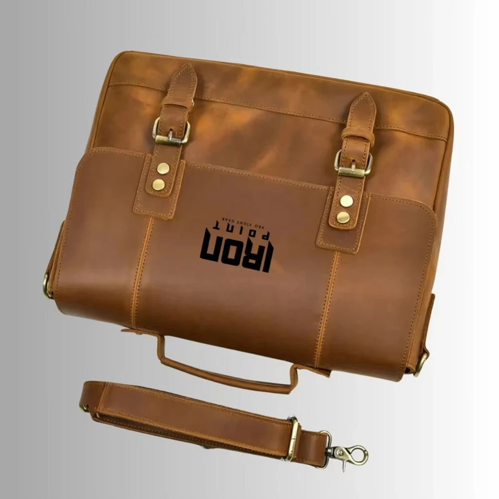 Brown leather business laptop briefcase with buckle straps, top handle, and detachable shoulder strap. #Trunks