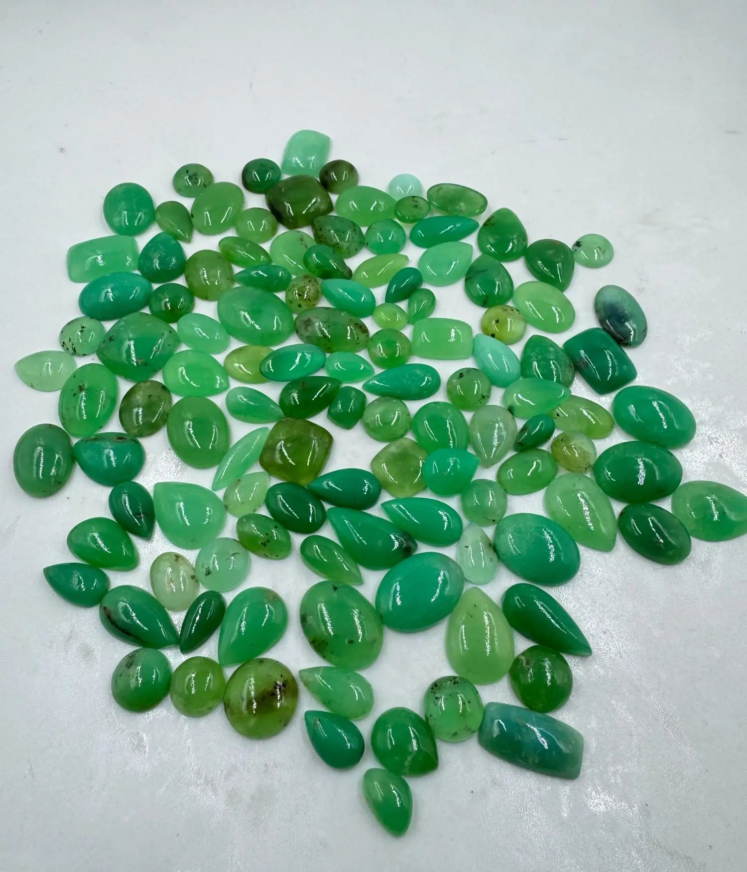Loose green gemstone cabochon mix, glossy oval and teardrop stones