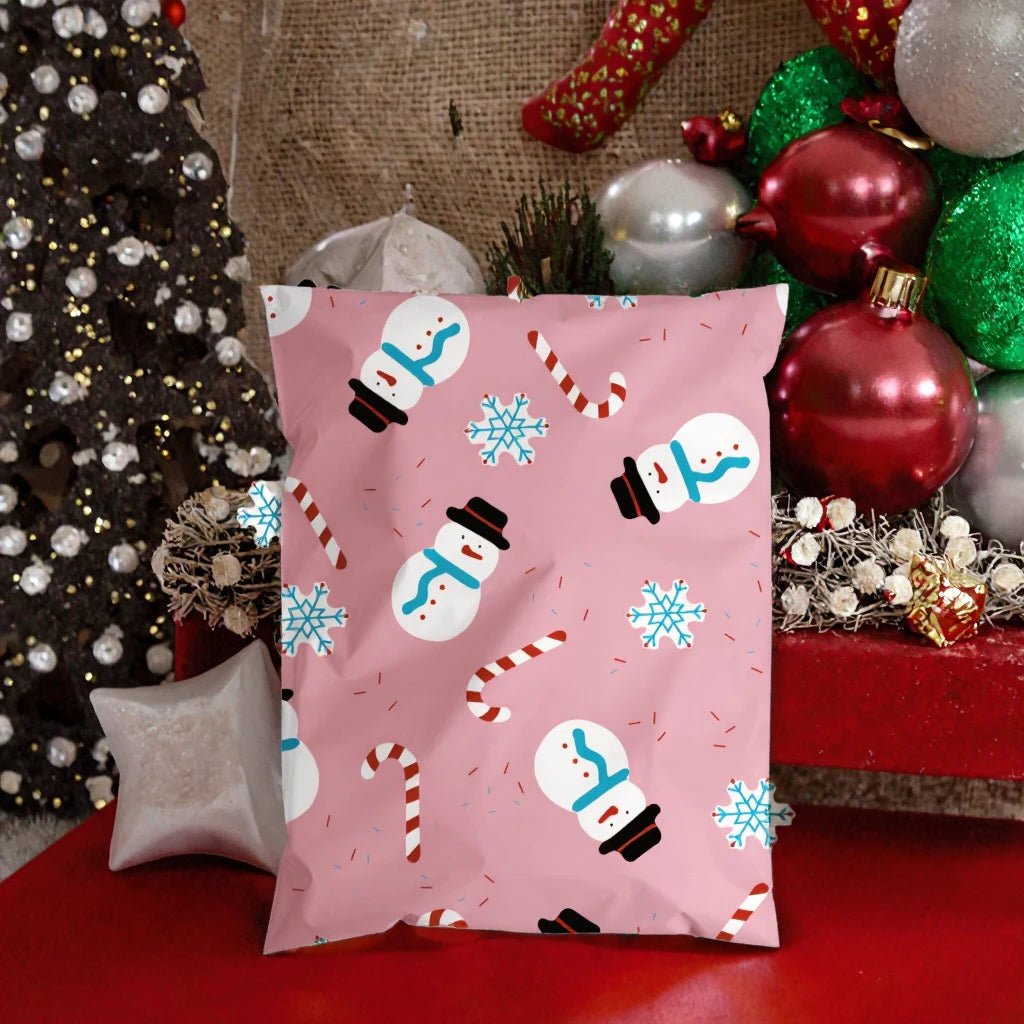 Light pink Christmas poly mailer bag with snowman, candy cane, and blue snowflake icons