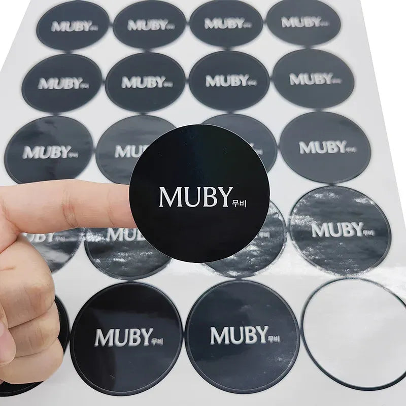 Round black logo seal stickers with MUBY print, adhesive vinyl label set