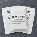 White poly mailing bags with RONGWEN mailing bags branding on gray fabric