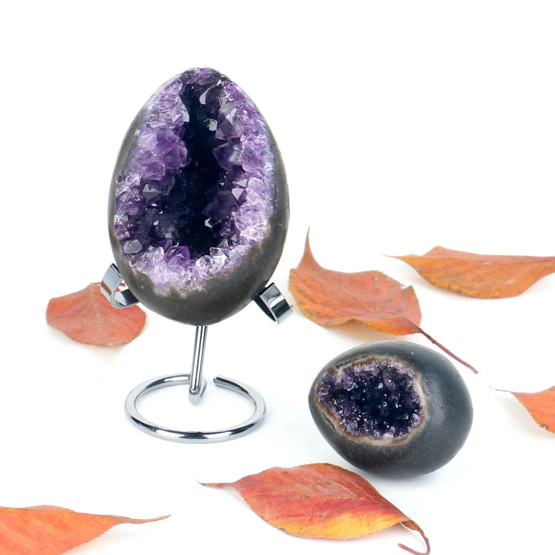 Amethyst crystal geode egg set on chrome stand, purple druzy interiors