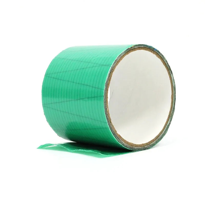 Green waterproof membrane tape roll with grid pattern, exposed inner cardboard core