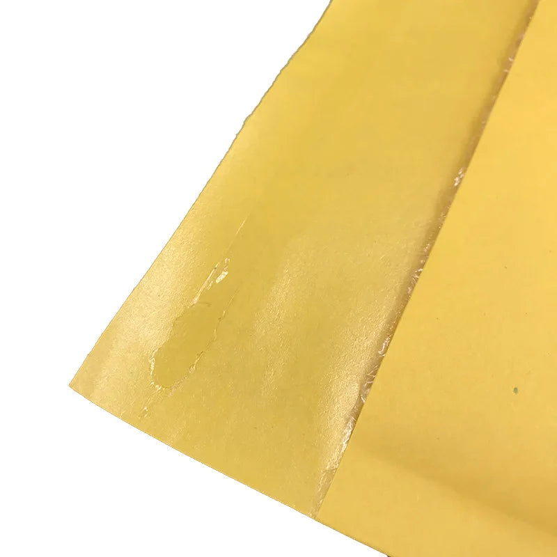 Yellow poly padded mailer edge with slight wear and taped fold