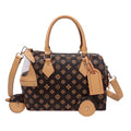 Brown PU leather trunk shoulder bag with tan trim, floral pattern, and playful tricycle-shaped wheel design.