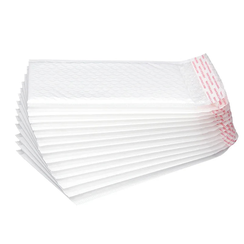 Stack of white plastic bubble mailer envelopes with ribbed edges and red label strip