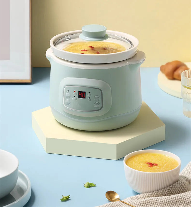 Mint 1L electric slow cooker on a stand, lid closed and soup visible